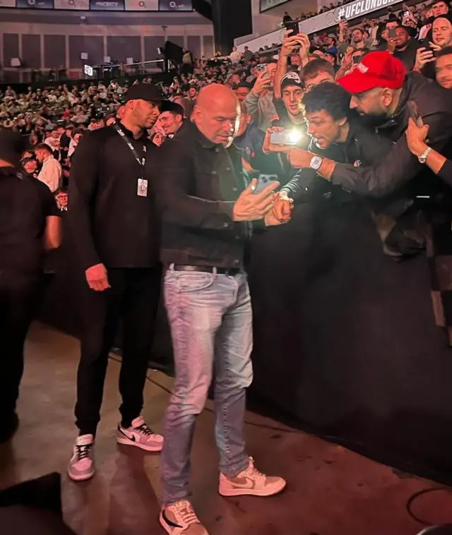 Dana White takes selfies with UFC fans