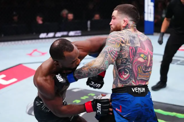 Leon Edwards and Sean Brady in the middle of the cage