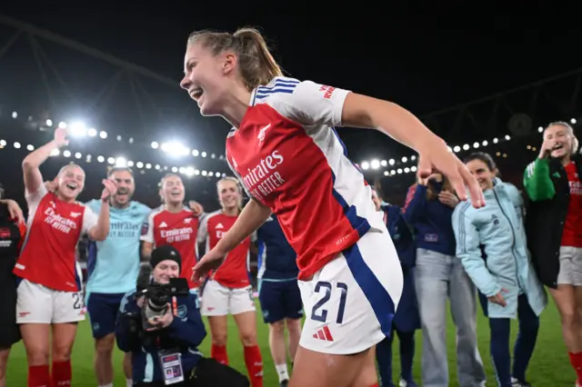 Victoria Pelova smiles as she runs into the middle of the team huddle at full time