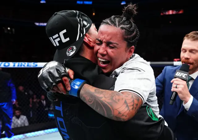 Pujar Tomar hugs her coach in the UFC octagon