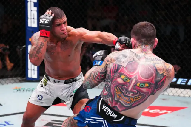 Gilbert Burns lands a punch on the chin of Sean Brady in the UFC octagon