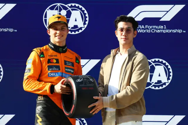 Oscar Piastri of Australia and McLaren receives his Pirelli Pole Posiiton Award from actor Aarif Lee