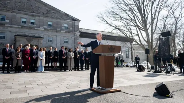 Mark Carney speaks at a lectern outside Rideau Hall in central Ottawa.