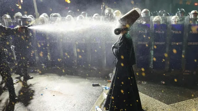 Police officers use pepper spray on a demonstrator wearing dervish clothes, during a protest on the day Istanbul Mayor Ekrem Imamoglu was jailed as part of a corruption investigation, in Istanbul, Turkey, March 2