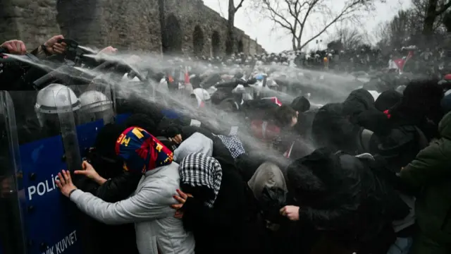 Turkish riot police use tear gas to disperse protesters gathering in front of the Aqueduct of Valens during a rally in support of Istanbul's arrested mayor in Istanbul Municipality