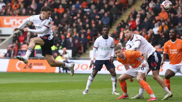 Aaron Collins of Bolton Wanderers scores to make it 1-1 and celebrates