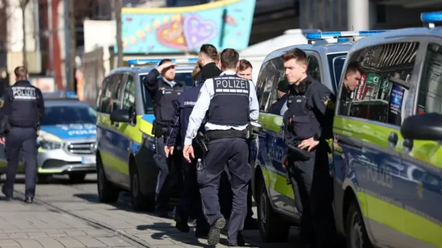 Police talk near the scene after a car drove into a crowd, in Mannheim