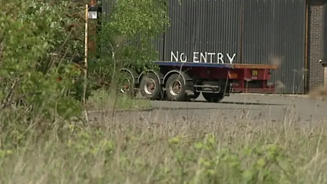 A "No Entry" sign on a warehouse door