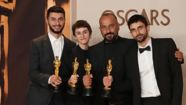 Basel Adra, Rachel Szor, Hamdan Ballal, Yuval Abraham pose for pictures holding their Oscars