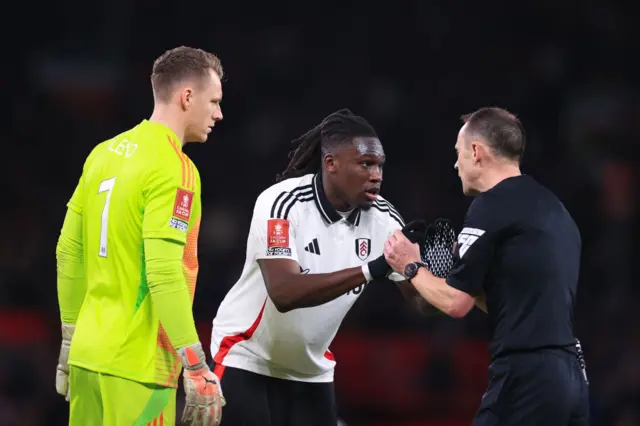 Calvin Bassey and Bernd Leno chat to referee Stuart Attwell