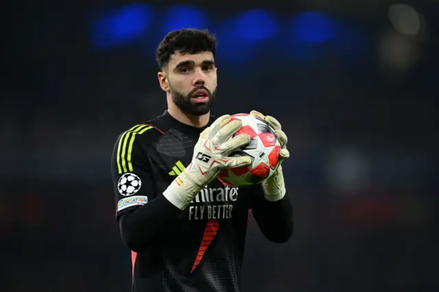 David Raya holds a football