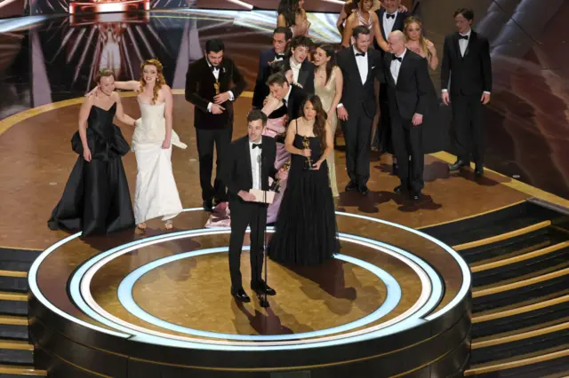 Cast and crew including Darya Ekamasova, Lindsey Normington, Vache Tovmasyan, Karren Karagulian, Alex Coco, Mikey Madison, Mark Eydelshteyn, Samantha Quan, Luna Sofía Miranda, Sean Baker, Drew Daniels and Yura Borisov accept the Best Picture award for "Anora" onstage during the 97th Annual Oscars at Dolby Theatre on March 02, 2025 in Hollywood, California. (Photo by Kevin Winter/Getty Images)