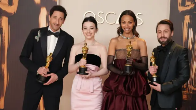 Adrien Brody, Mikey Madison, Zoe Saldaña, and Kieran Culkin pose for photos after their oscar wins.