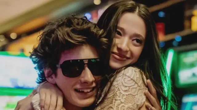 Mikey Madison embraces Mark Eidelstein in scene set in a casino from Anora