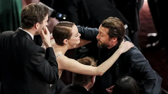 Emma Stone hugs Kieran Culkin during the ceremony