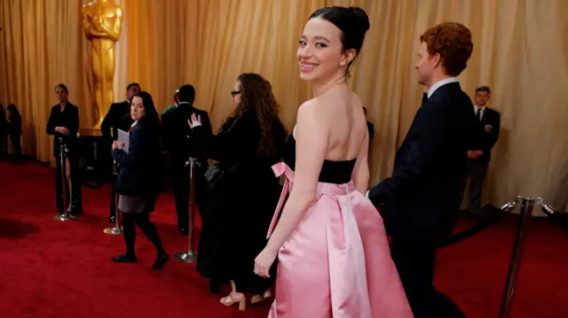 Mikey Madison heads backstage to the winners room