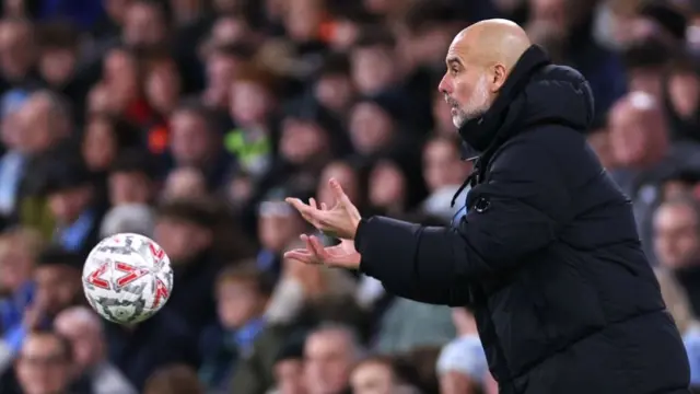 Pep Guardiola manager of Manchester City throws the match ball during the FA Cup.