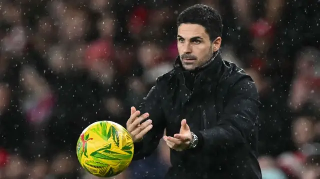 Mikel Arteta throws the ball during the English League Cup quarter-final match.