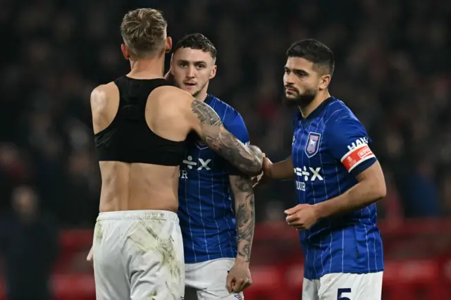 Jack Taylor (C) is consoled by teammates after his penalty miss.