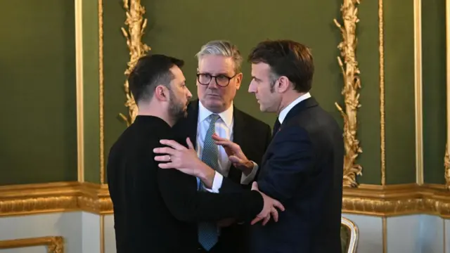 Zelensky and Macron and Starmer embrace in a meeting