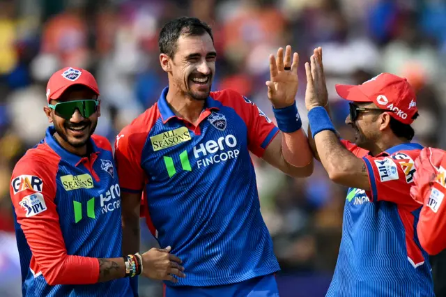 Delhi Capitals fast bowler Mitchell Starc celebrates the wicket of SRH batter Travis Head