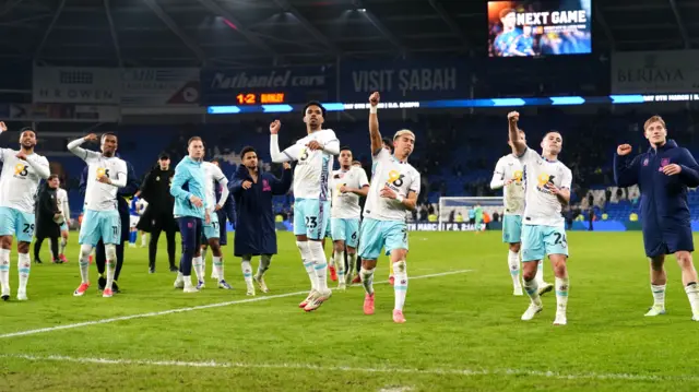 Burnley players celebrate in front of the travelling support