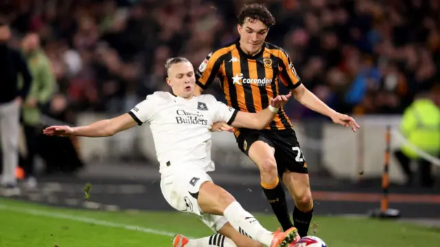 Kyle Joseph of Hull City is challenged by Plymouth's Maksym Talovierov