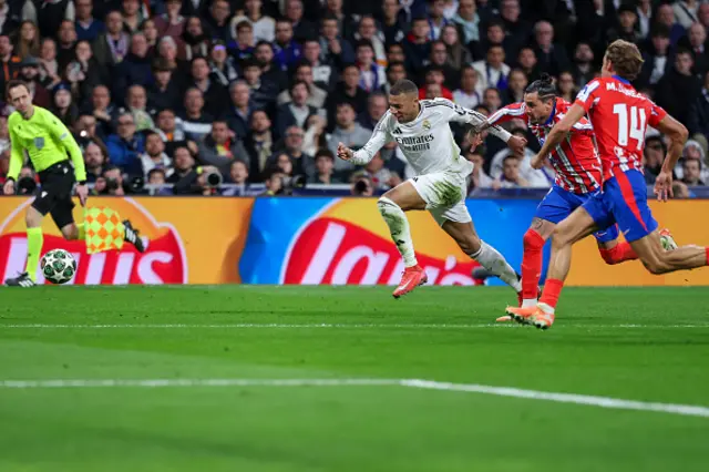 Kylian Mbappe (L) runs for the ball