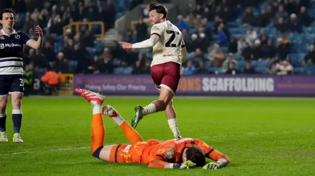 Harry Cornick peels away to celebrate after scoring Bristol City's second at Millwall as goalkeeper Lukas Jensen lies on the pitch