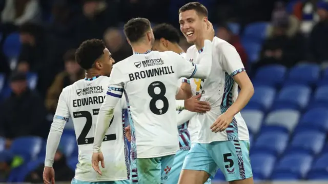 Burnley players celebrate with Maxime Esteve after his goal at Cardiff