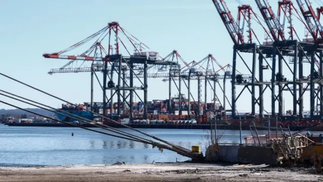 Containers are unloaded from a ship at the Port Newark Container Terminal on 3 March 2025 in Newark New Jersey.