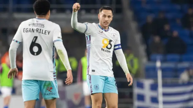 Burnley captain and goalscorer Josh Brownhill raises a fist in celebration