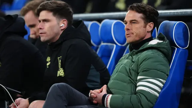 Scott Parker takes his seat in the dugout at Cardiff City Stadium