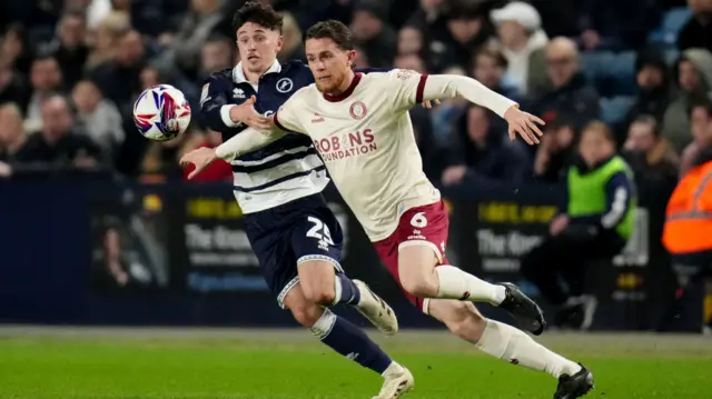 Bristol City's Max Bird is challenged by Luke Cundle of Millwall