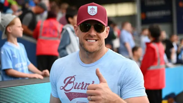 JJ Watt gives a thumbs up to the camera while in Burnley gear