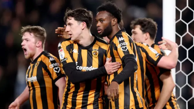 Hull players celebrate with Abu Kamara