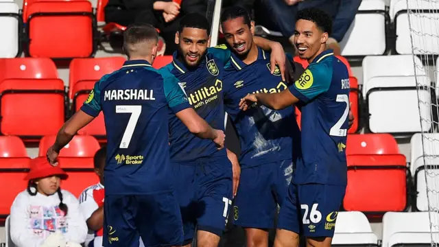 Huddersfield players celebrate scoring against Wrexham