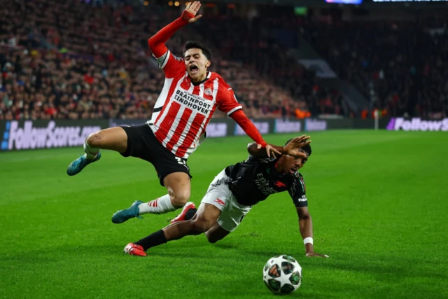 PSV Eindhoven's Richard Ledezma in action with Arsenal's Myles Lewis-Skelly