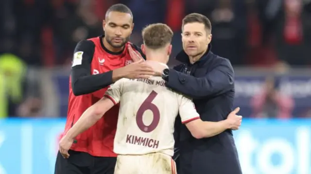 Xabi Alonso and Jonathan Tah greet Joshua Kimmich