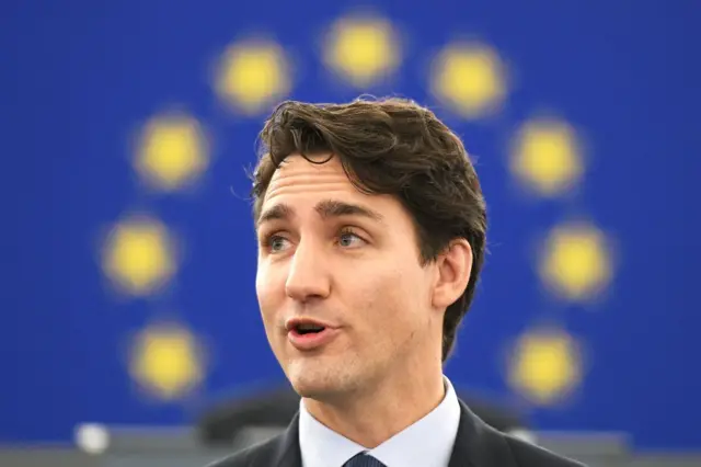 Justin Trudeau at the European Parliament in Strasbourg in 2017, in front of EU flag