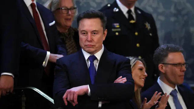 Elon Musk wearing a suit