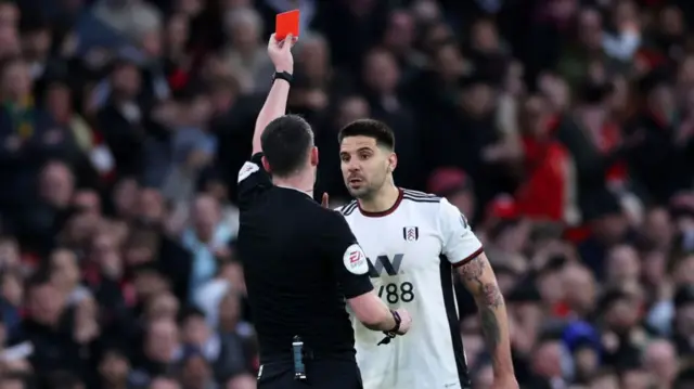 Fulham forward Aleksandar Mitrovic is shown a red card by referee Chris Kavanagh