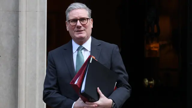 Starmer departs 10 Downing Street holding two folders