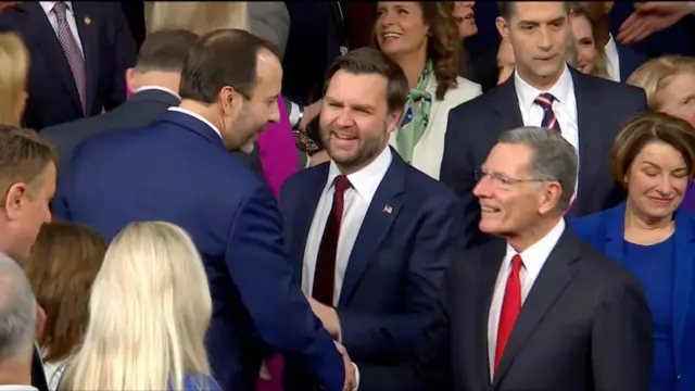 JD Vance smiling in middle of group of people