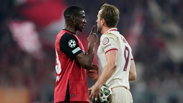 Nordi Mukiele of Bayer 04 Leverkusen (L) speaks with Harry Kane