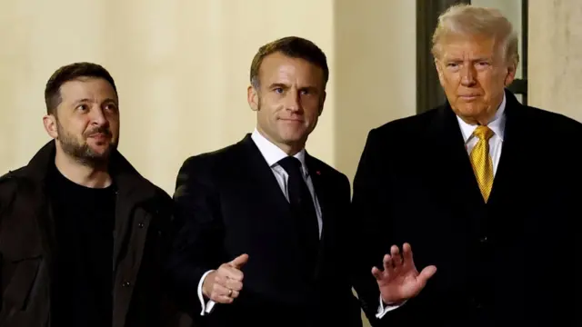 Zelensky (L), Macron (C) and Trump (R) stand outside the Elysee Palace in wintertime wearing heavy black coats