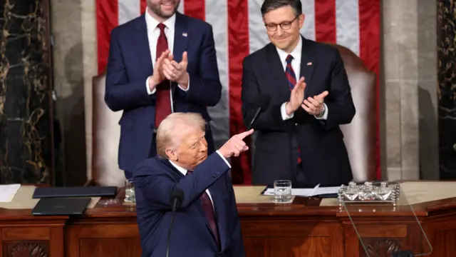 Donald Trump pointing in Congress with JD Vance and Mike Johnson applauding behind