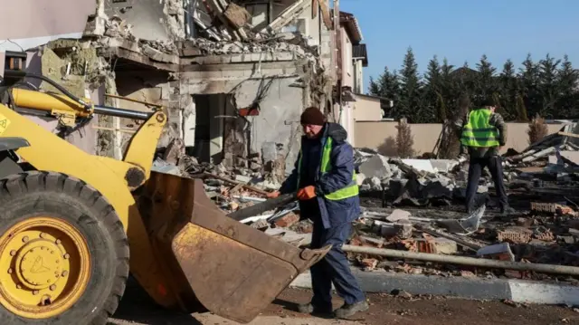 Municipal workers are also working to remove debris at the site of a house partly detsroyed by Russian strikes