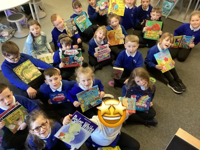 A picture of school students holding books up for World Book Day