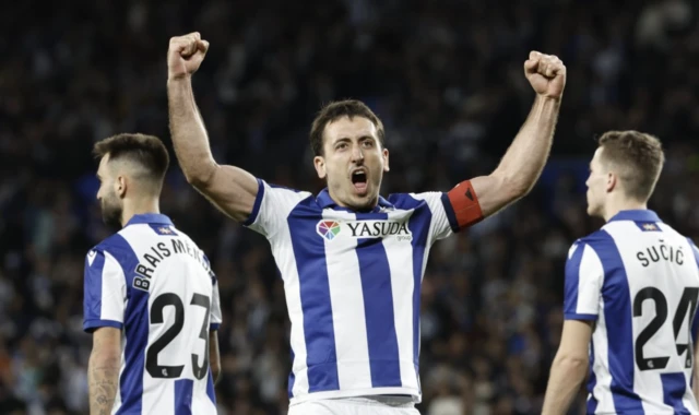 Real Sociedad's Mikel Oyarzabal (C) celebrates with teammates